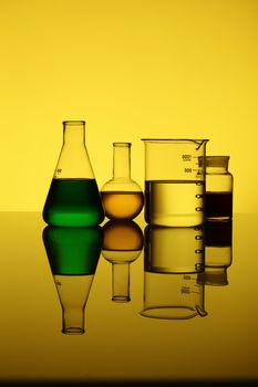 Glass chemistry tubes on a colour background