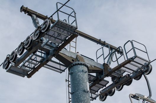 Mast of a chairlift, on cloudy sky.