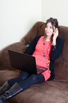 woman at home using notebook on couch