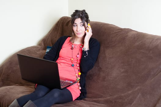 woman at home using notebook on couch