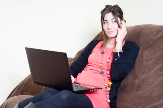 woman at home using notebook on couch