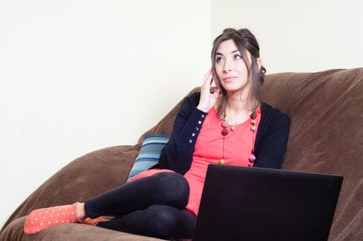 woman at home using notebook on couch