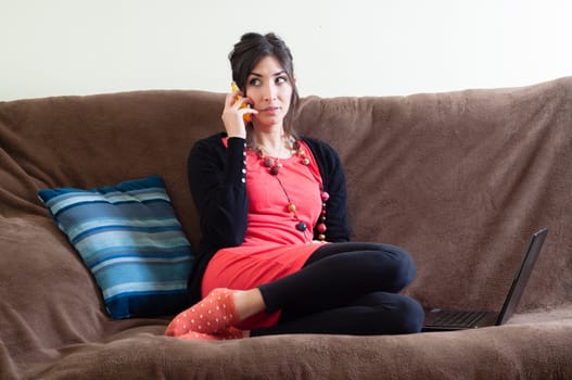 woman at home using notebook on couch