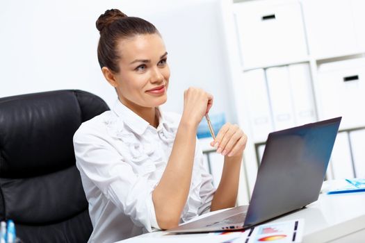 Young manager working with notebook in the office