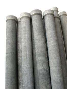 Stack of many asbestos pipes on white background