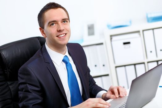 Young manager working with notebook in the office