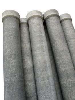 Stack of many asbestos pipes on white background