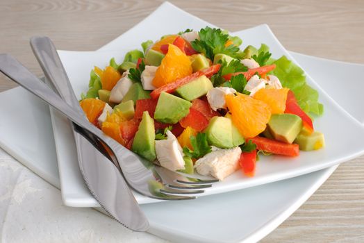 Chicken salad with avocado, sweet pepper and orange