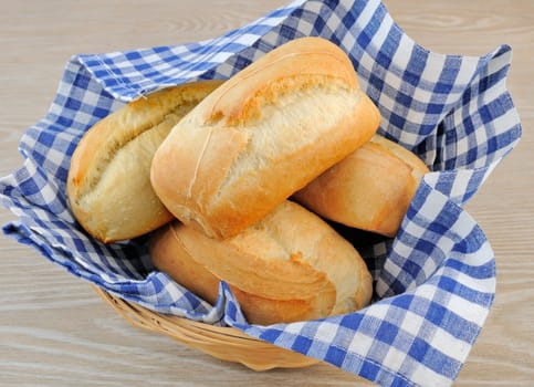 Fresh bread in a basket with a napkin shelter