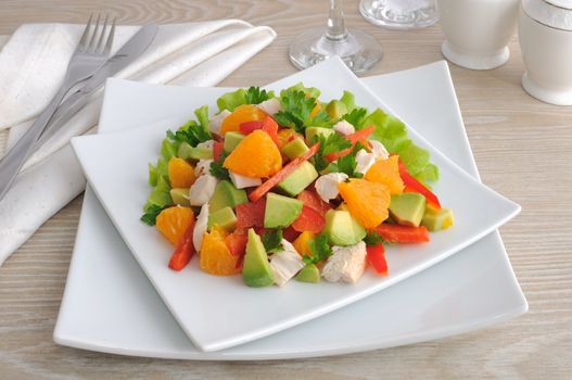 Chicken salad with avocado, sweet pepper and orange