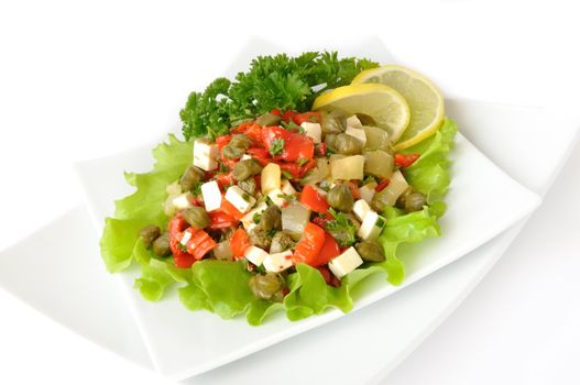 A salad of red peppers with goat cheese, capers, fresh herbs in the marinade