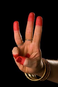 Woman hand showing Thishul hasta (hand gesture, also called mudra) (meaning "trident") of indian classic dance Bharata Natyam. Also used in other indian classical dances Kuchipudi and Odissi.