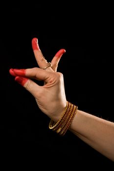 Woman hand showing Katakamukha hasta (meaning "Opening in a Bracelet") of indian classic dance Bharata Natyam