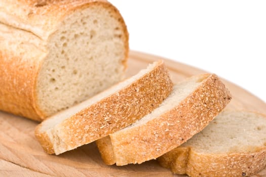 Sliced bread on wooden plate - shallow depth of field