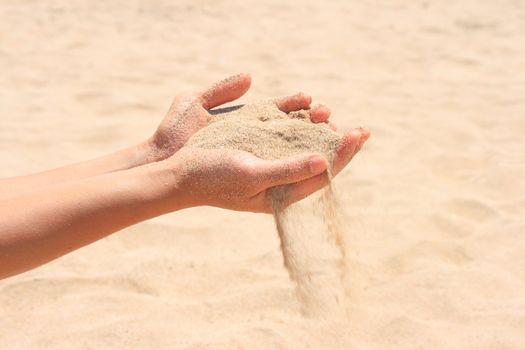 Sand running through hands