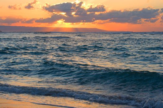 Calm peaceful ocean and beach on tropical sunrise