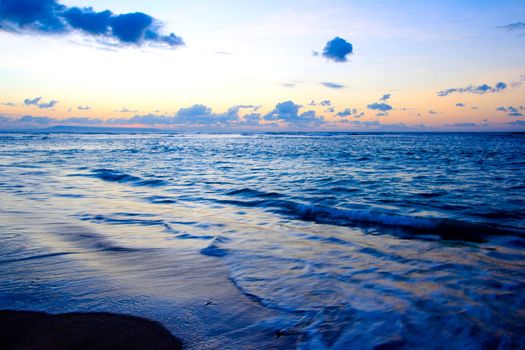 Calm peaceful ocean and beach on tropical sunrise