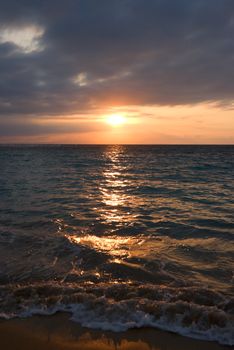 Calm peaceful ocean and beach on tropical sunrise