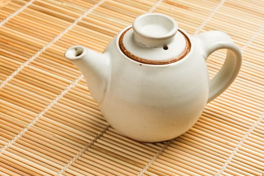 Chinese teapot on bamboo mat close up photo