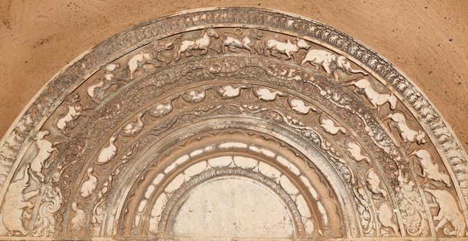 Ancient moonstone at the entrance of Buddhist dagoba (stupa). Anuradhapura, Sri Lanka