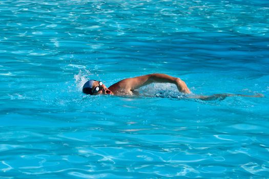 Athletic Man swimming in the pool