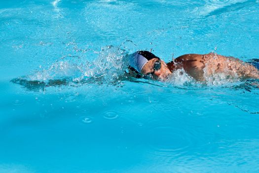 Athletic Man swimming in the pool