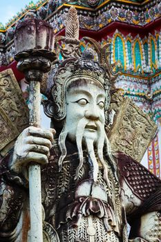 Chinese stone guardian statue close up in Wat Pho Buddhist Temple , Bangkok, Thailand