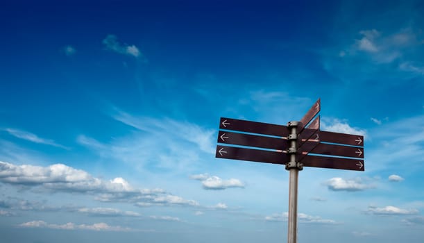 Blank signpost in sky with clouds