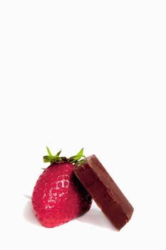 Fresh strawberry and a dark chocolate bar isolated