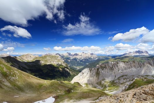 summer view of Monzoni valley with Sassolungo and Catinaccio mount on background, Italian Dolomites