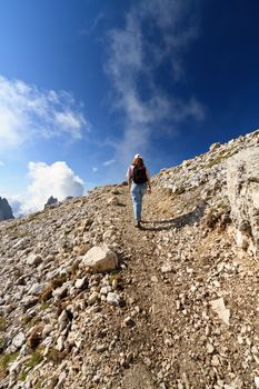 hiker walks on Pale di San Martino mount, Trentino, Italy