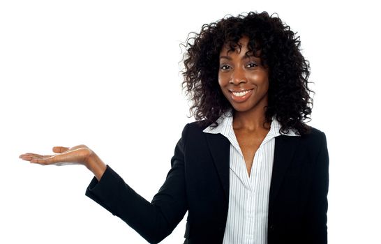 Isolated woman presenting copyspace, smiling at camera