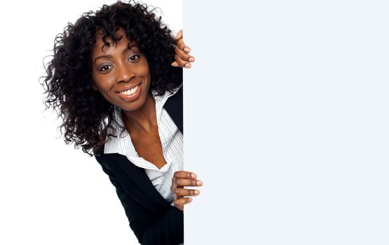 Businesswoman holding a long blank banner ad isolated over white background