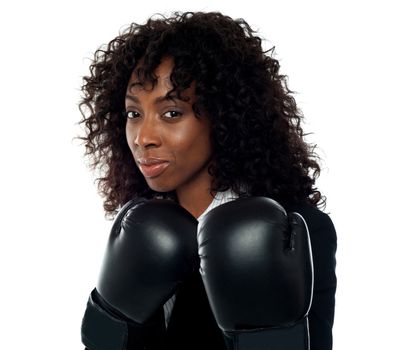 Beautiful female executive wearing boxing gloves. Get ready for some action