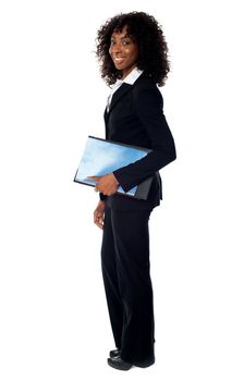 Full length portrait of african corporate lady holding folder and clipboard