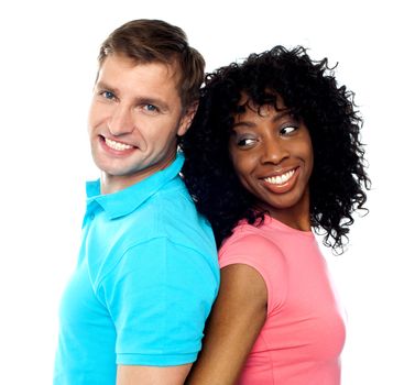 Closeup shot of young attractive couple posing back to back