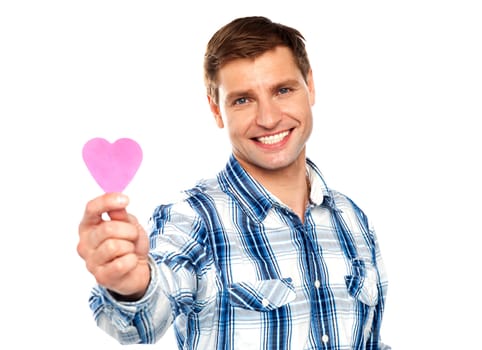 Man showing pink paper heart shaped cutting against white background