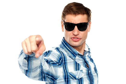 Cool fashionable guy pointing at you wearing sunglasses