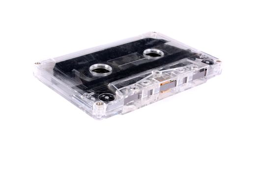 An old audio tape cassette, on a white studio background.