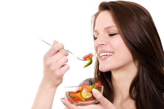 closeup of a young happy woman eating salad on white background