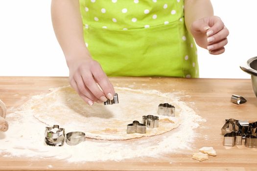 woman hands using christmas molds on dough