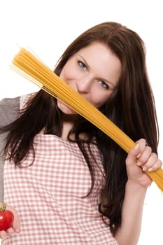 young woman holding spaghetti to her face holding tomato on white background