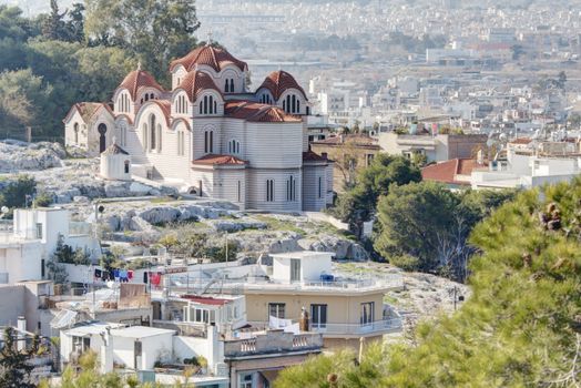 Agia Marina or Saint Marina orthodox church situated on the Hill of the Nymphs in Athens, Greece. The city of Athens can be seen in the background.