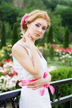 Romantic sensual woman among rose garden