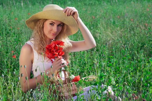 Woman in hat with poppy bouquet in midow