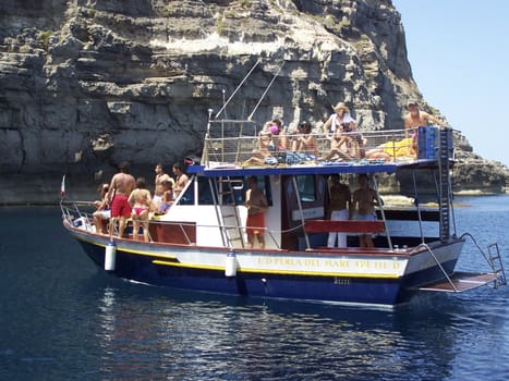 LAMPEDUSA - AUGUST 2007 - Tourists during a boat trip off the coast of Lampedusa on 14 August, 2007 in Lampedusa, Sicily, Italy