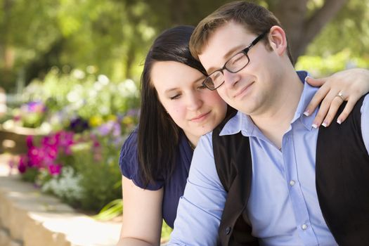 Attractive Young Engaged Couple Relaxing in the Park Together.