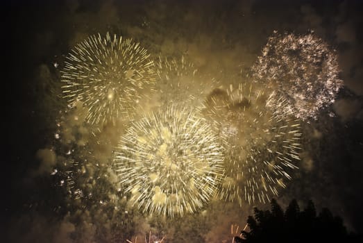 Colorful fireworks over dark sky, displayed during a celebration of Santa