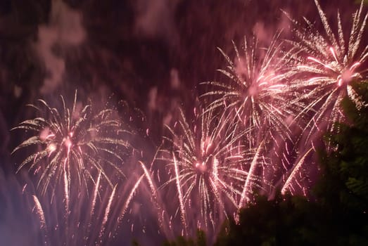 Colorful fireworks over dark sky, displayed during a celebration of Santa