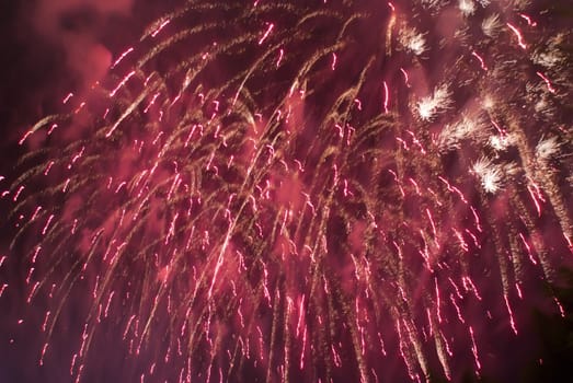 Colorful fireworks over dark sky, displayed during a celebration of Santa